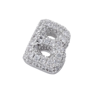 Macro detail of silver letter B charm pendant featuring micro-paved clear cubic zirconia