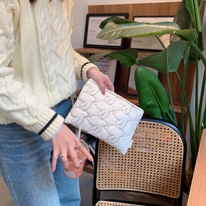 Detail of white quilted bunny pouch featuring a soft texture and cute embroidery