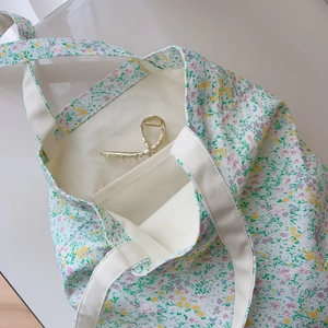 Detail view of cotton tote bag interior with floral print and inner pocket