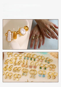 Detail of 18K gold plated jewelry set with pearls and diverse charms on warm background