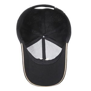 Black baseball cap with mesh back and beige trim, showing interior lining and mesh structure