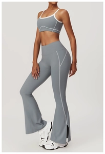Detail view of grey yoga set with white contrast stitching and side split flare pants