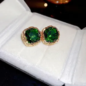 Square emerald zircon stud earrings with vintage gold plating in a white velvet jewelry box