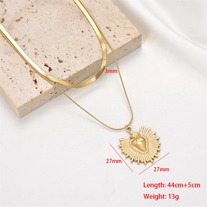 Detailed view of gold double layer necklace showing 3mm snake chain and 27mm heart pendant