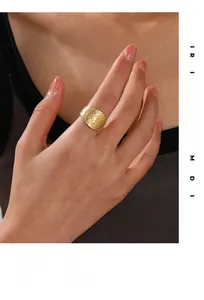 Macro shot of gold vintage religious cross emblem ring worn in a lifestyle setting