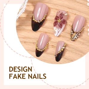 Almond press-on nails with 3D floral accents, rhinestones, and French gradient design