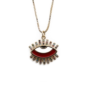 Detailed macro of gold plated evil eye pendant with red enamel and colored zircons