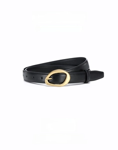 Close-up of black cowhide leather belt with a minimalist golden oval metal buckle