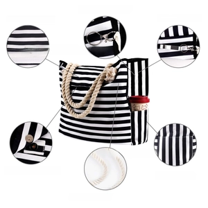 Nautical canvas tote detail with rope handles, inner pockets, and magnetic closure