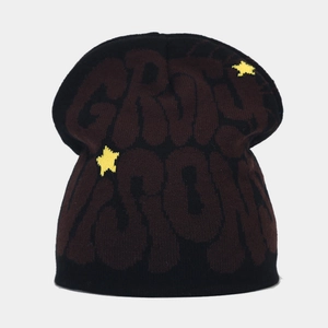 Detail of chunky knit beanie with dark coffee jacquard text and yellow star accents