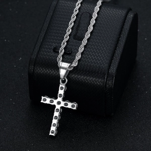 Silver hip hop cross pendant necklace with black stones and twist chain on display