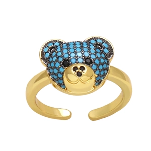 Adjustable golden ring with a cute bear head design paved with blue stones on white base