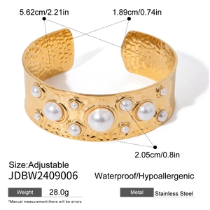 Detailed view of hammered 18k gold plated stainless steel cuff with pearl and size markings