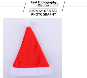 Close-up of classic red velvet Christmas hat with soft white plush trim and fluffy pompom