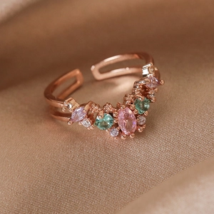 Macro shot of rose gold V-shaped open ring featuring pink zircon and colorful gemstones