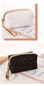 Detail of star pattern cosmetic bags with gold zippers and textured woven fabric
