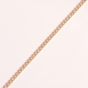 Detailed close-up of a gold-plated claw-set necklace featuring pink round-cut cubic zirconia