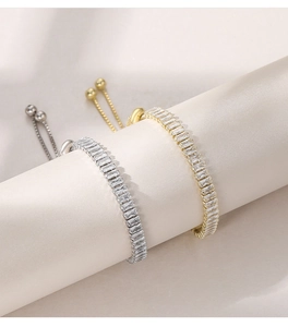 Macro detail of gold and silver adjustable bracelets with sparkling cubic zirconia stones