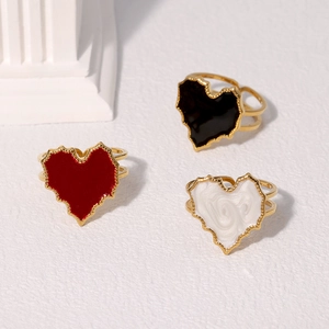 Three minimalist heart-shaped enamel rings in gold finish with adjustable open bands