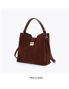 Side view of dark brown suede handbag with golden buckle and detachable shoulder strap