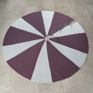 Detail of 48-inch knitted Christmas tree skirt with red and grey radial striped pattern