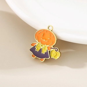 Detailed view of a gold-plated Halloween pumpkin pendant with orange and purple enamel