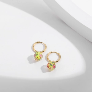 Detail of gold-plated stainless steel earrings with colorful floral glass beads