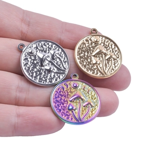 Macro shot of celestial mushroom pendants in gold, silver and iridescent finishes