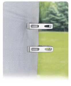 Close-up of a stainless steel bed sheet clip securely holding grey textured fabric