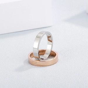 Polished silver and frosted rose gold stainless steel couple rings in a minimalist style