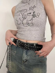Close-up of black punk leather belt with silver rivets and y2k style metal chain