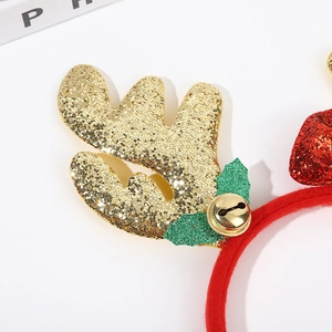 Christmas headband with gold glitter antlers, green leaves, and a red glitter bow ornament