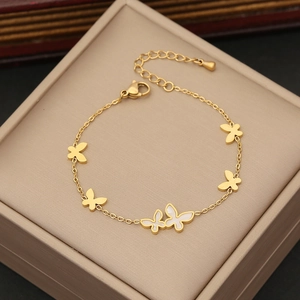 Detail of gold butterfly bracelet with white mother of pearl inlay on jewelry box