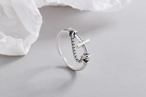 Detail shot of vintage s925 silver cross ring with chain design and open adjustable band