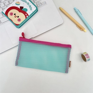 Close-up of contrast mesh pencil case with zipper and brand label on a desk setup