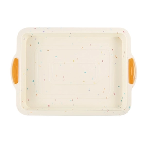 Rectangular cream silicone brownie pan with colorful sprinkles and orange handles