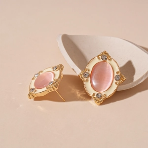 Macro shot of vintage gold earrings with pink opal stone and small diamonds in detail
