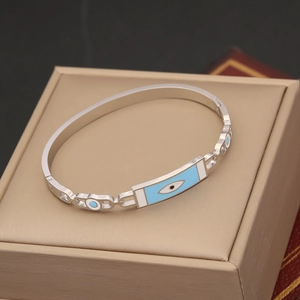 Silver stainless steel evil eye bangle with light blue enamel on a jewelry gift box