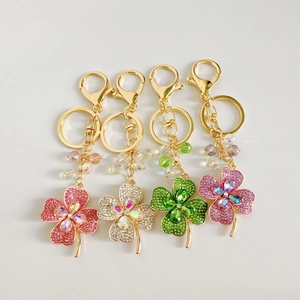 Detail view of colorful rhinestone clover keychains with crystals in four vibrant colors