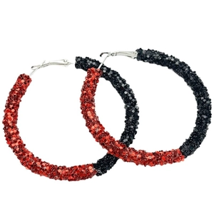 Detail of large hoop earrings with sparkling red and black sequins and silver metal clasp