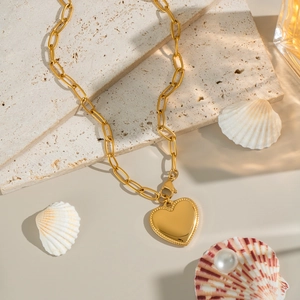 Elegant 18K gold plated stainless steel heart pendant necklace on natural stone surface