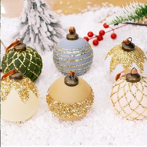 Set of six 8cm painted Christmas balls with glitter and ribbons on a snowy background