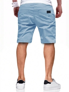 Back view of men's light blue casual shorts featuring dual rear pockets and a small black patch