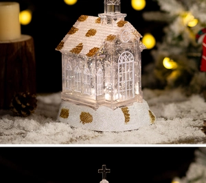 Detail of crystal church music box with warm LED light and snow accents for Christmas