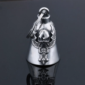 Detailed close-up of a stainless steel skull wing motorcycle bell pendant with reflection