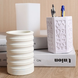 Detail of DIY resin silicone mold with finished embossed cylinder and hexagonal pen holders