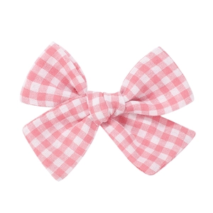 Close-up of the fine texture on this pink gingham fabric bow hair clip for girls