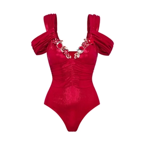 Close-up of V-neck pink metallic swimsuit with 3D floral and rhinestone detailing
