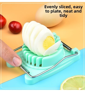 Detail of manual egg slicer with stainless steel wires cutting a boiled egg into slices