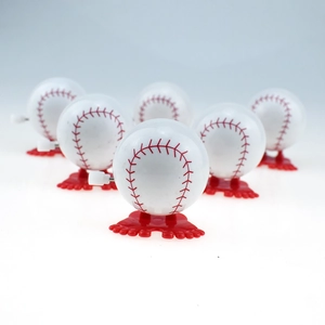 Detailed view of wind-up baseball toys with white bodies and red mechanical legs